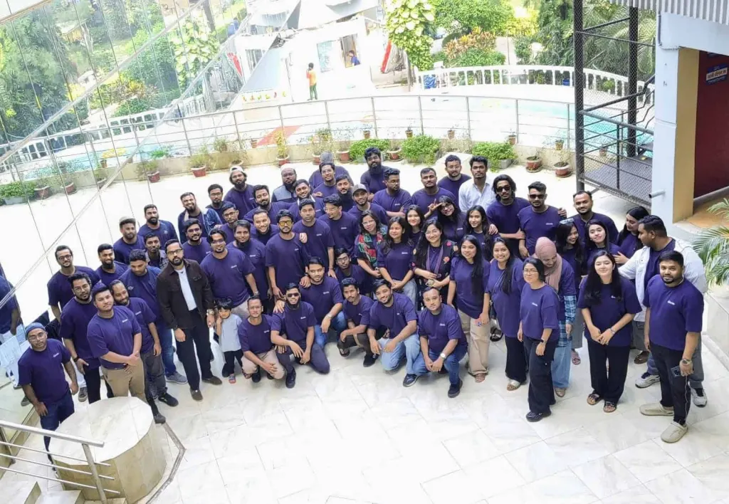 The Innospace team in matching purple shirts at the office