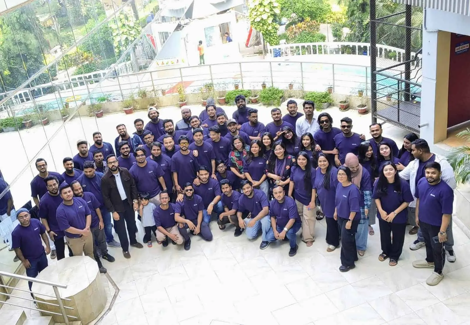 The Innospace team in matching purple shirts at the office