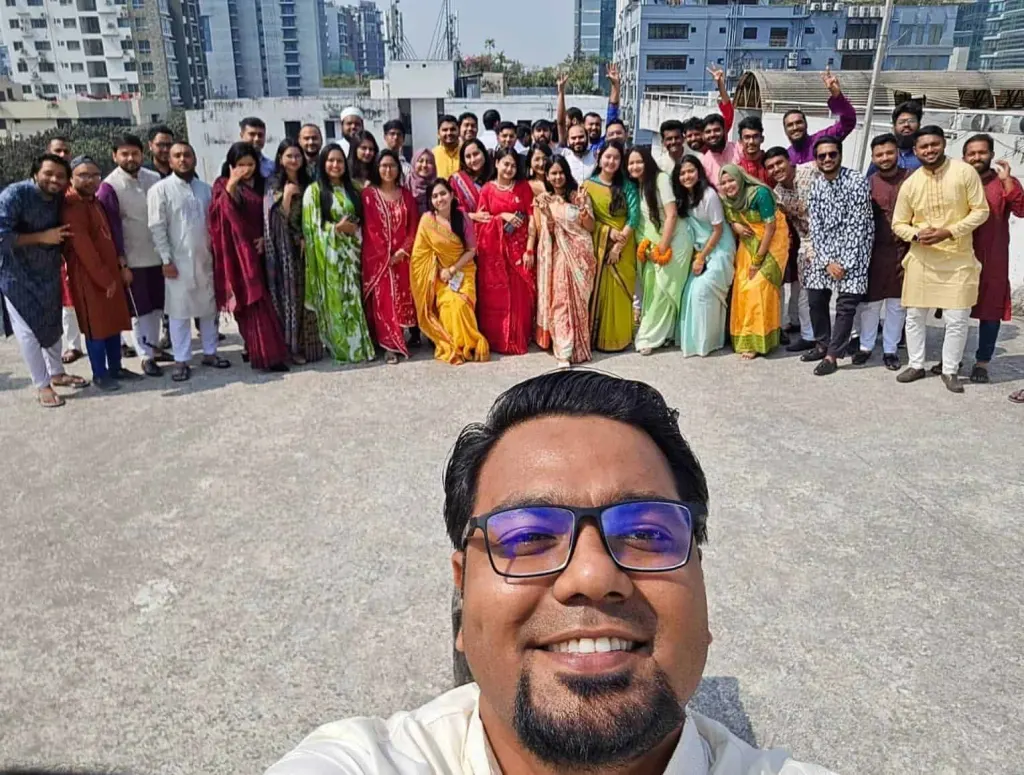 A team selfie on the office rooftop during a celebration